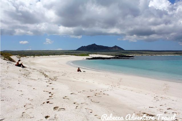 People relaxing on a white sandy beach in Galapagos 