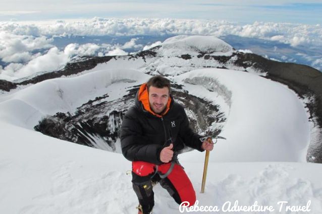 Happy guy posing after his climbing Cotopaxi and reaching its summit