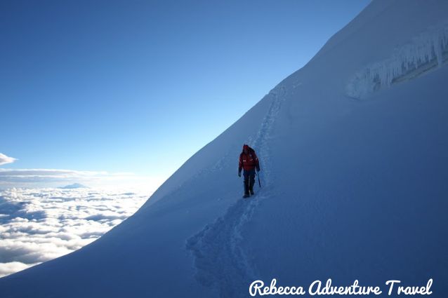 Tourist climbing the snowy Cotopaxi